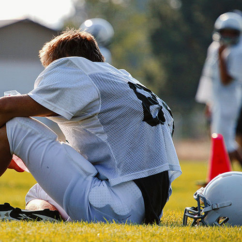 A football player sitting on the field